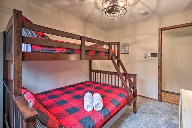 54 Spencer Ln, Albrightsville, PA 18210 - carpeted bedroom with baseboards and a chandelier