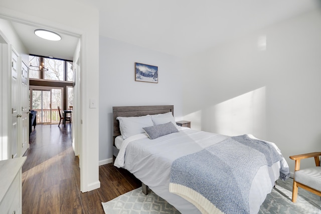 bedroom with baseboards and wood finished floors