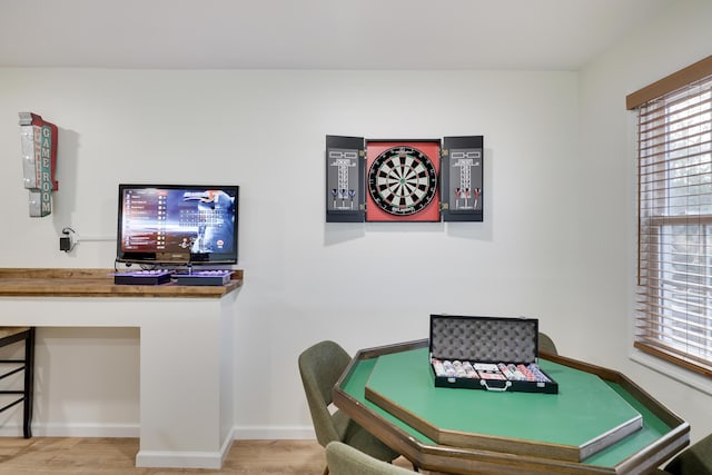 playroom featuring baseboards and wood finished floors