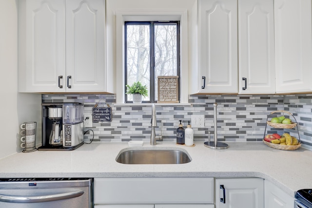 kitchen with white cabinetry, plenty of natural light, a sink, and stainless steel appliances