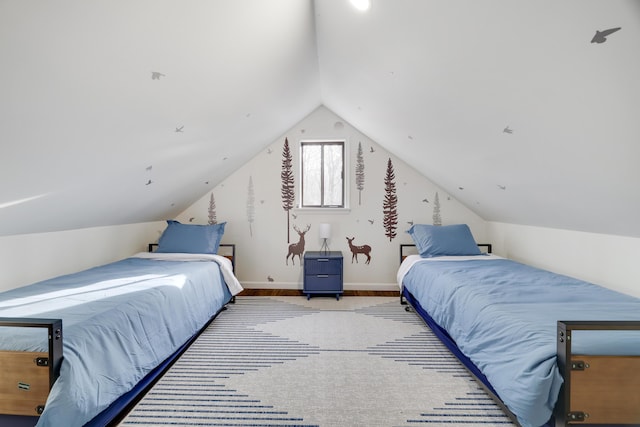 bedroom featuring vaulted ceiling and baseboards