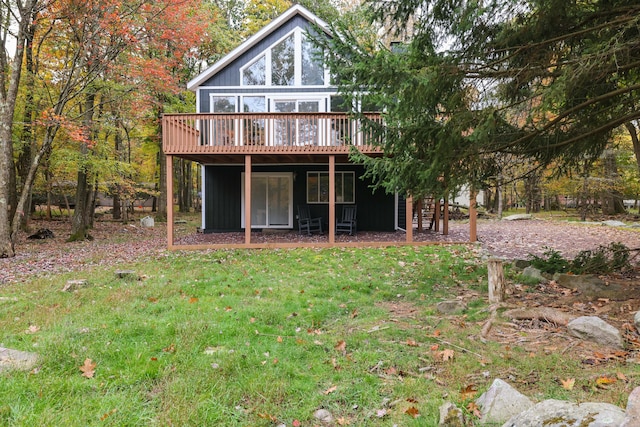 back of property featuring stairway, a yard, and a deck