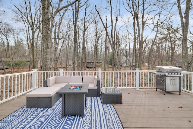 deck featuring an outdoor living space with a fire pit and a grill