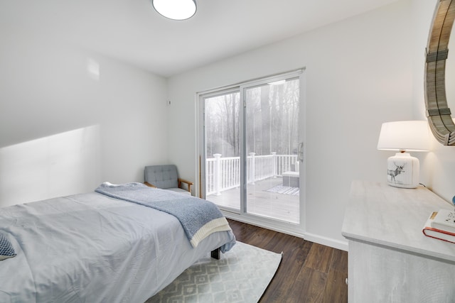 bedroom featuring access to exterior, wood finished floors, and baseboards