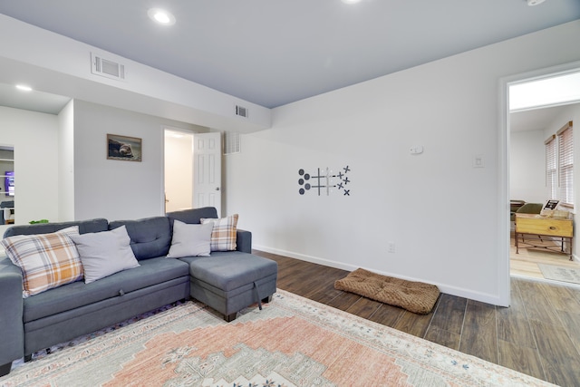 living area with visible vents, recessed lighting, baseboards, and wood finished floors