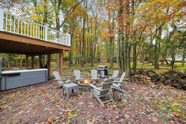 view of yard with a deck and an outdoor fire pit