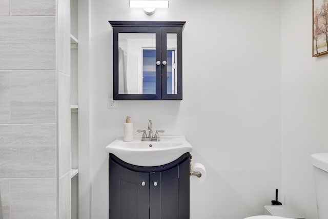 bathroom featuring toilet and vanity