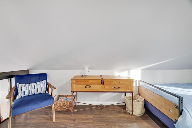 bedroom with vaulted ceiling and wood finished floors