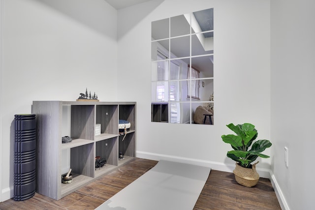 interior space with baseboards and wood finished floors