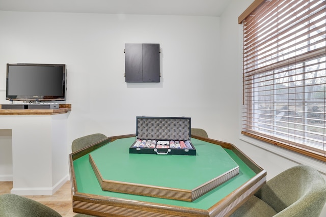 interior space with a wealth of natural light, baseboards, and wood finished floors