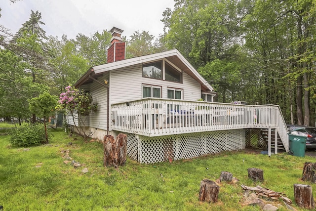 1900 Horseshoe Bnd, Tobyhanna, PA 18466 - back of house with a chimney, a wooden deck, a lawn, and stairs