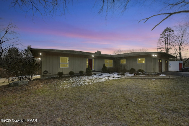 ranch-style home featuring a yard