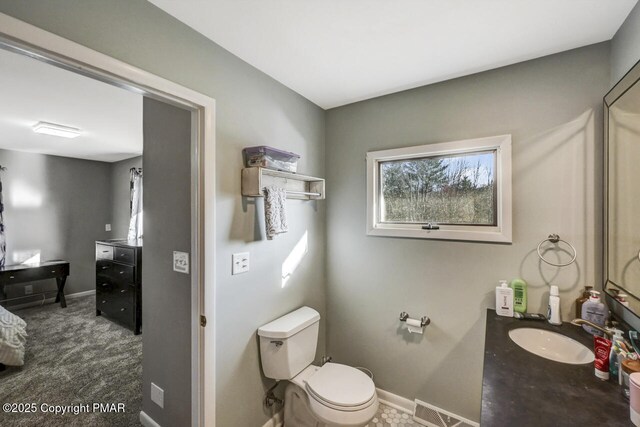 bathroom featuring vanity and toilet