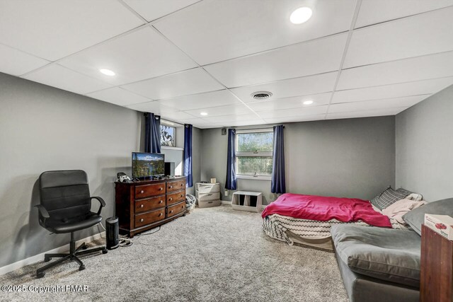 bedroom featuring carpet floors and a paneled ceiling