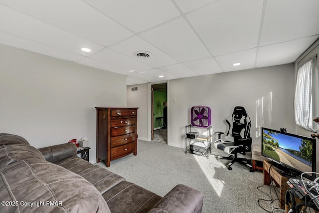 living room with light carpet and a drop ceiling