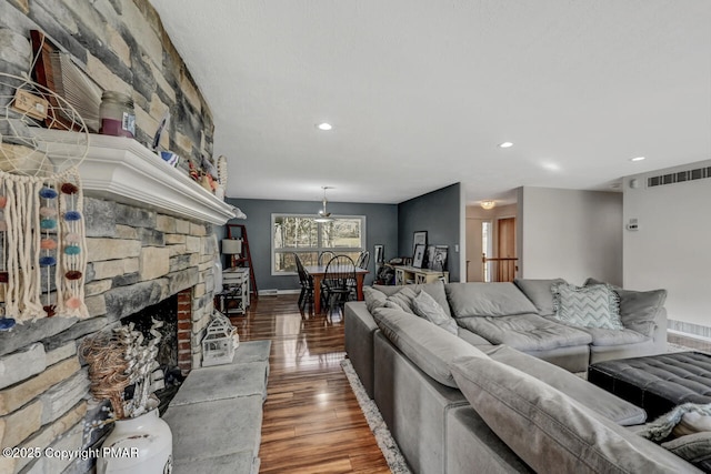 living room with wood-type flooring and a fireplace