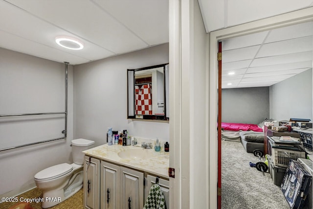 full bathroom with toilet, vanity, bath / shower combo with glass door, and a drop ceiling