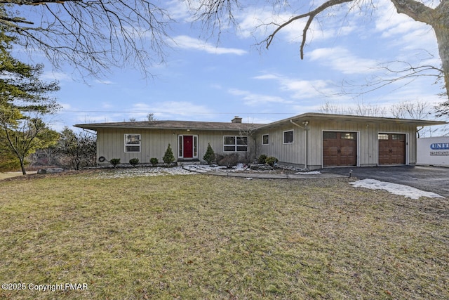 single story home featuring a garage and a front yard