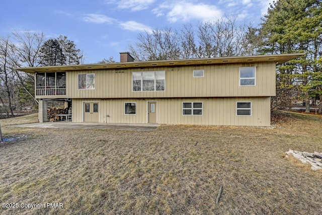 rear view of property featuring a patio area and a sunroom