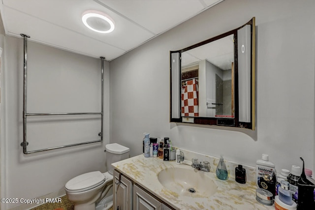 bathroom featuring walk in shower, vanity, and toilet