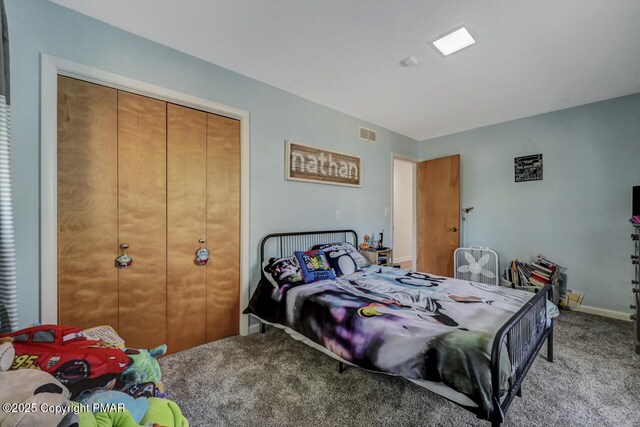 carpeted bedroom with a closet