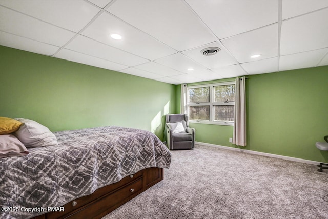 bedroom featuring carpet flooring and a paneled ceiling