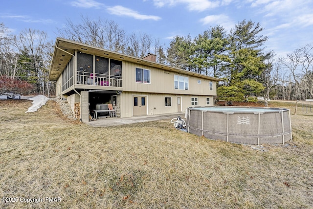 back of house featuring a yard, a sunroom, a patio, and central air condition unit