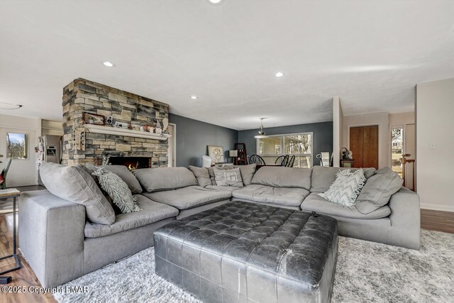 living room with wood-type flooring and a fireplace