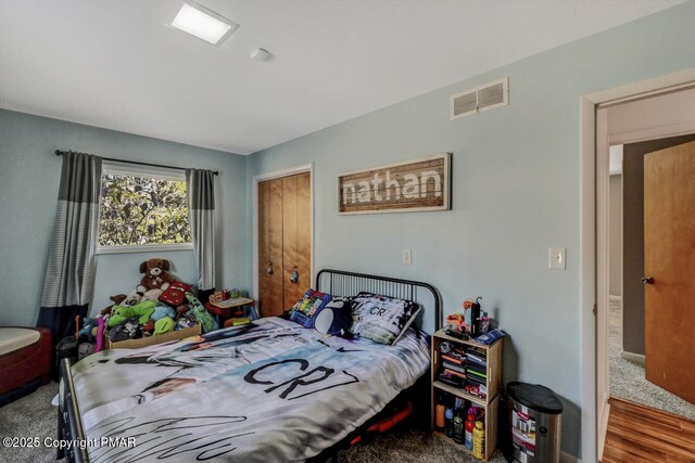 bedroom featuring hardwood / wood-style floors and a closet