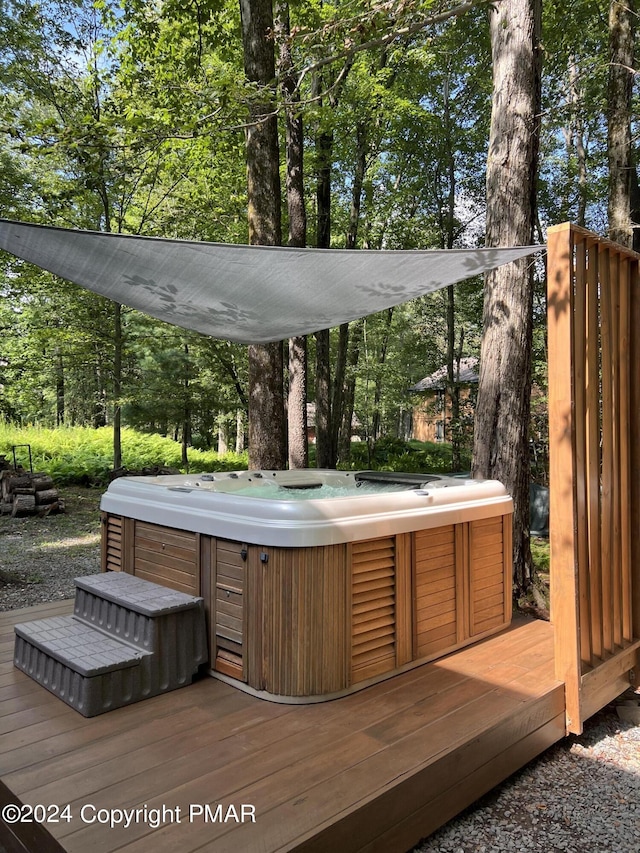 wooden terrace featuring a jacuzzi