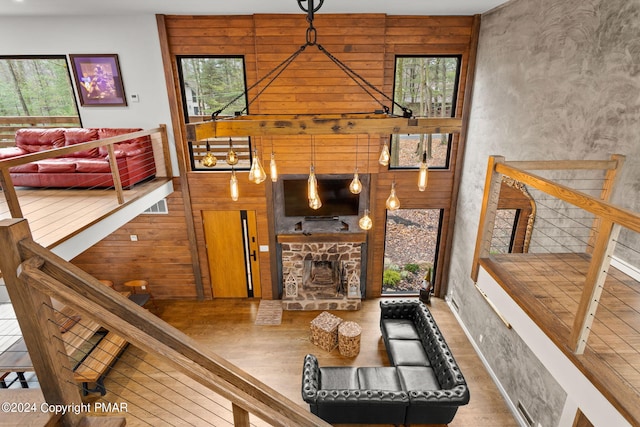 living room featuring a stone fireplace and wood finished floors