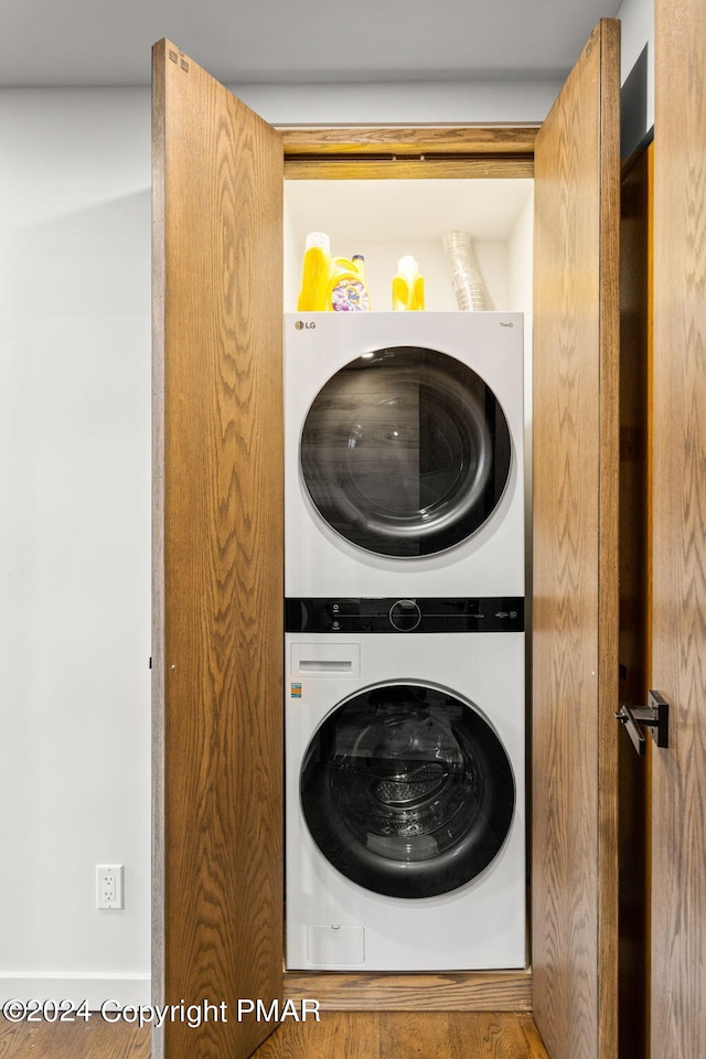 laundry area with stacked washer / dryer and laundry area