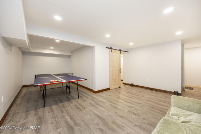 1212 Acacia Dr, Hawley, PA 18428 - game room with recessed lighting, a barn door, baseboards, and wood finished floors