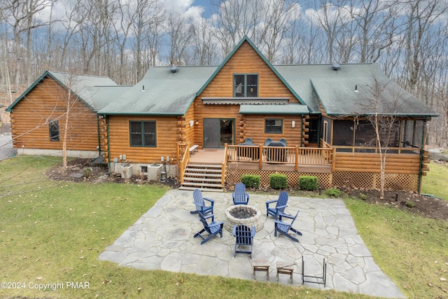 1212 Acacia Dr, Hawley, PA 18428 - back of house featuring a patio, a wooden deck, log siding, a yard, and a sunroom