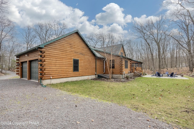 1212 Acacia Dr, Hawley, PA 18428 - view of property exterior featuring driveway, log siding, an attached garage, a fire pit, and a lawn
