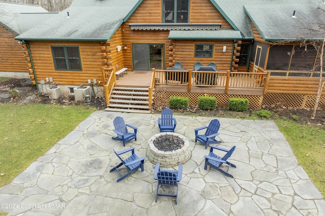 1212 Acacia Dr, Hawley, PA 18428 - rear view of property featuring a wooden deck, log exterior, an outdoor fire pit, and a patio