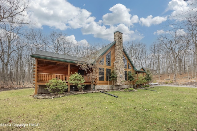 1212 Acacia Dr, Hawley, PA 18428 - back of property with log siding, a lawn, and roof with shingles