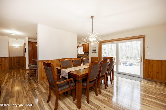 1212 Acacia Dr, Hawley, PA 18428 - dining room with a wainscoted wall, an inviting chandelier, wood walls, and light wood finished floors