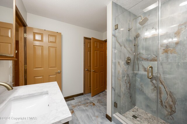 1212 Acacia Dr, Hawley, PA 18428 - full bathroom featuring a marble finish shower, baseboards, and vanity