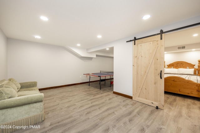 1212 Acacia Dr, Hawley, PA 18428 - game room with a barn door, wood finished floors, visible vents, and baseboards