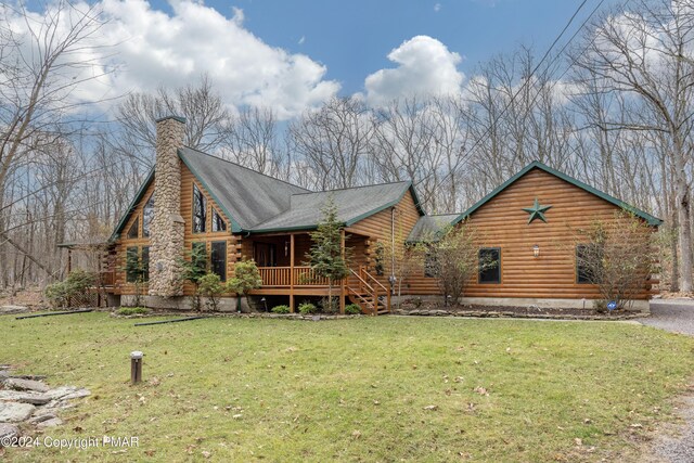 1212 Acacia Dr, Hawley, PA 18428 - back of house featuring gravel driveway, log exterior, a yard, and a chimney