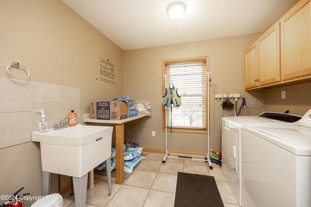 1212 Acacia Dr, Hawley, PA 18428 - laundry area with light tile patterned floors, baseboards, cabinet space, and washing machine and dryer