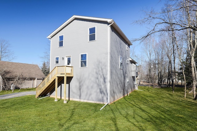 back of property featuring a yard and stairs