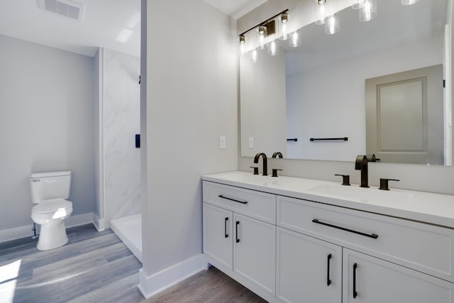 full bathroom featuring a sink, visible vents, toilet, and a shower stall