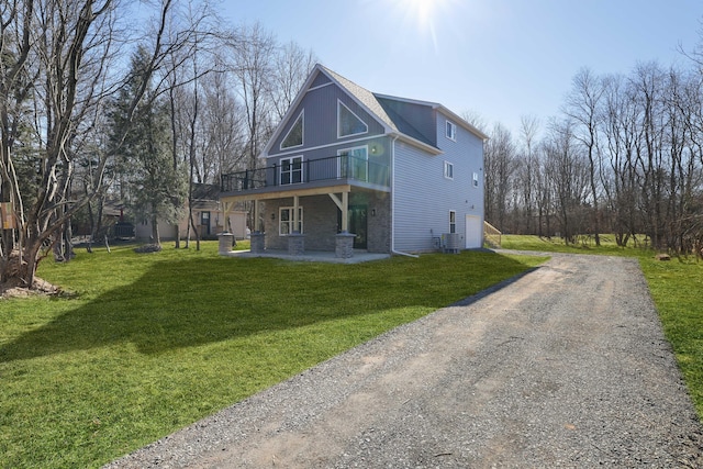 back of property featuring a yard, central AC, driveway, and a patio area