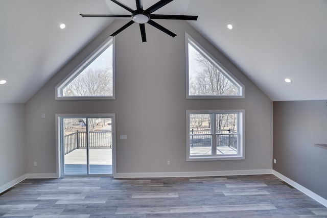 unfurnished living room with light wood-style floors, a healthy amount of sunlight, and baseboards