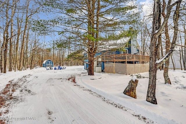 yard layered in snow with a wooden deck