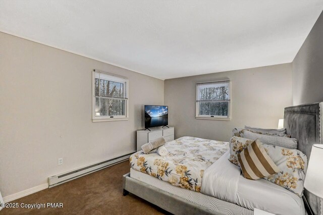 carpeted bedroom featuring a baseboard heating unit