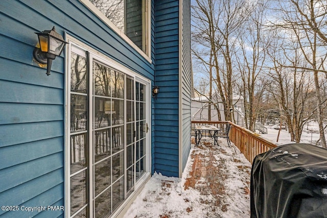 snow covered property featuring a wooden deck