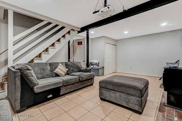 living room featuring beam ceiling and light tile patterned floors